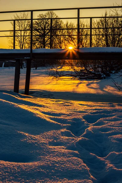 Snowy Bridge in a Countryside with the Sun Rays Gloving over it Directly into the Camera - Creating Sun Star