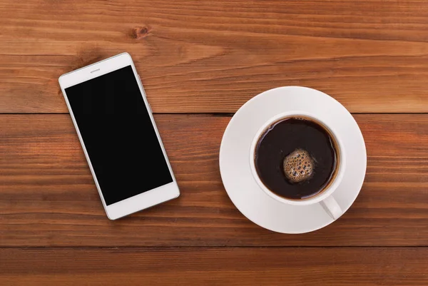 Xícara de café e telefone celular — Fotografia de Stock