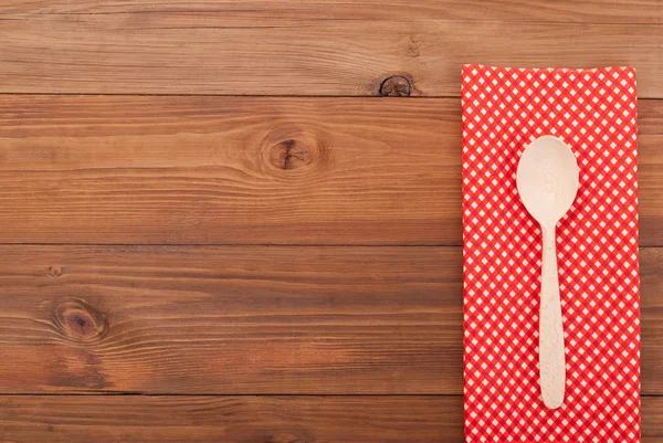 Spoon and napkin on wooden background. — Stock Photo, Image