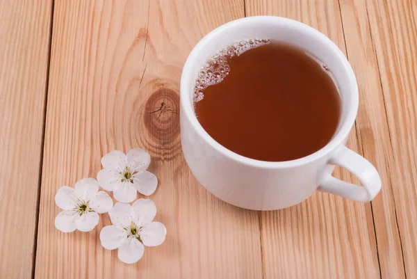 Tea and flower on a wooden background. View from above . — Stock Photo, Image