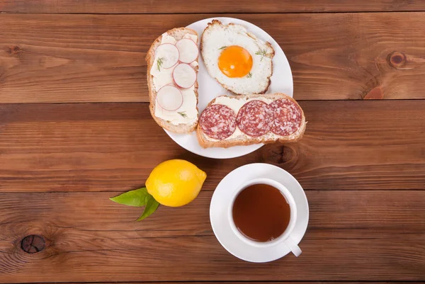 Sandwiches and tea on a wooden background. — Stock Photo, Image
