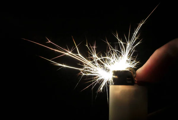 Sparks take colorful crystalline shapes as they come out of a cigarette lighter — Stock Photo, Image