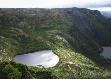 Wilks Lake sits nestled on a plateau in the Cradle Mountain - Lake St Clair National Park, Tasmania clipart