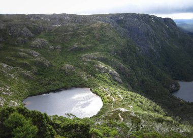 Wilks Lake sits nestled on a plateau in the Cradle Mountain - Lake St Clair National Park, Tasmania clipart