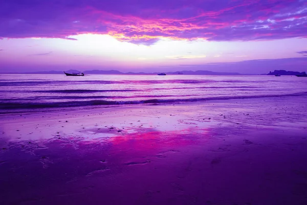 beach with beautiful twilight sky in purple and red.