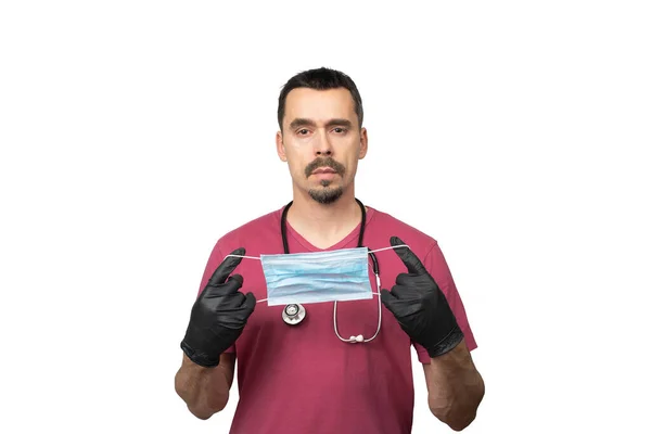 Siyah eldivenli bir doktor ya da hemşire koruyucu bir maske tutuyor.