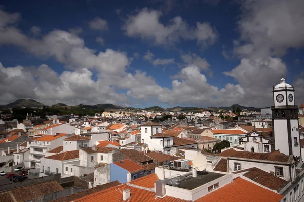 Multicolored view of of Ponta Delgada city on Sao Miguel island, Azores. Red roofs, white houses, blue cloudy sky