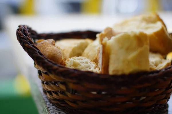 Closeup of fresh white bread for breakfast in brown wicker basket. Macro photo, bread texture