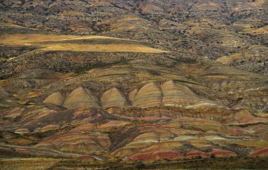 Amazing rocky desert on Georgia Azerbaijan border. Yellow brown red earth rock material covering hills. View from top