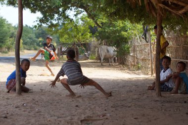 Bagan, Burma Myanmar - 11 Kasım 2012. Birmanyalı çocuklar küçük bir köyde futbol oynuyorlar. Genç bir çocuk topu yakalıyor.