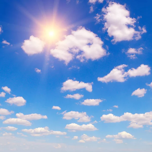 Sun on blue sky with white clouds — Stock Photo, Image