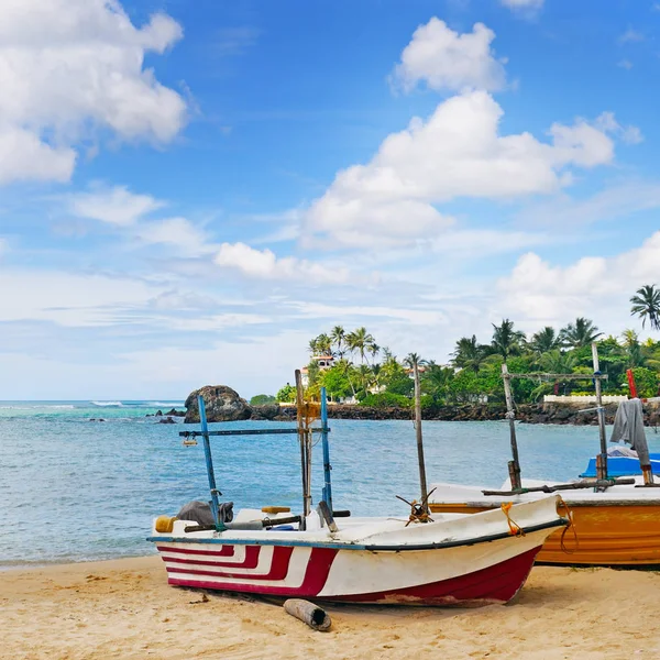 Bateau de pêche sur le rivage sablonneux sur un fond l'océan a — Photo