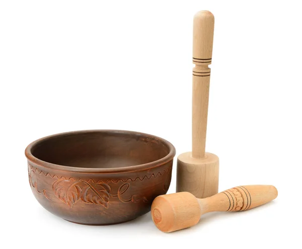 Earthenware dish and wooden pestle isolated on white background — Stock Photo, Image