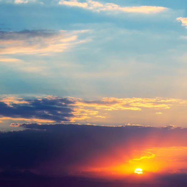 Heldere zonsondergang en hemel met donkere wolken — Stockfoto