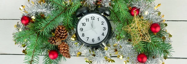 Retro alarm clock and Christmas tree decorations on a white wood — Stock Photo, Image