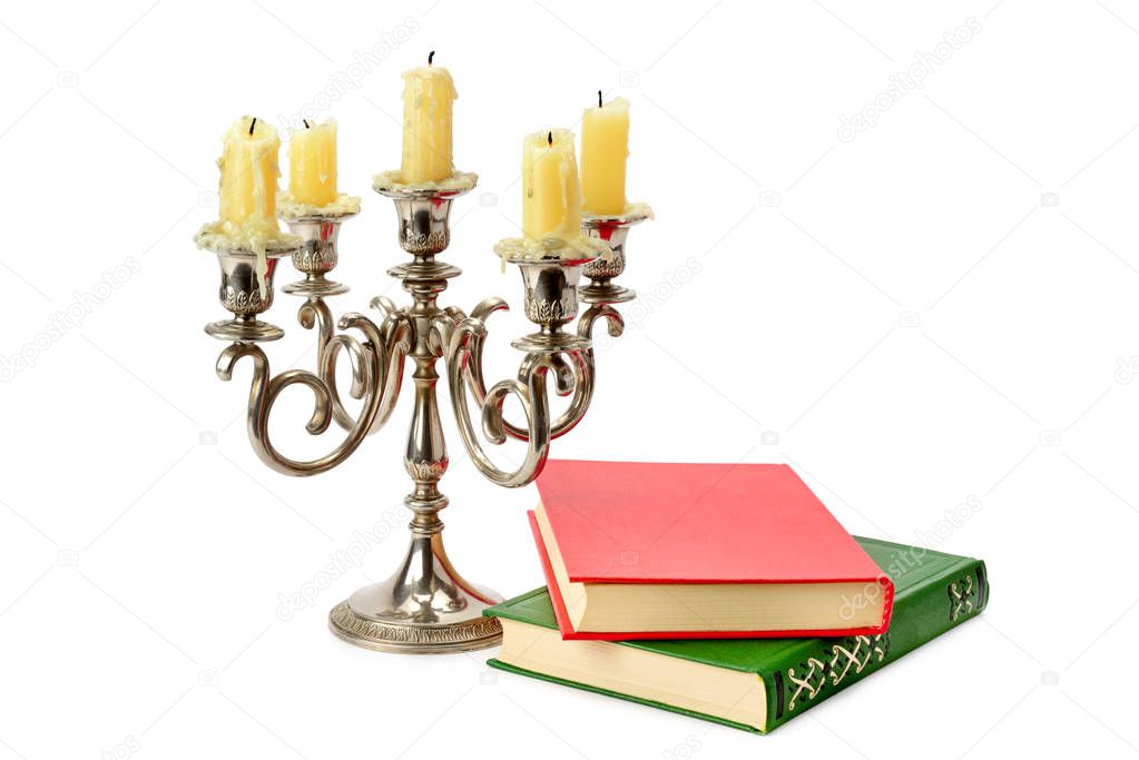 Sconce with candles and books isolated on white background.