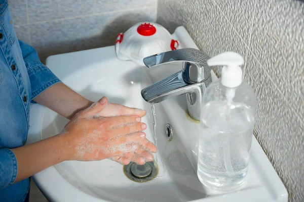 Coronavirus pandemic prevention wash hands with soap warm water and , rubbing nails and fingers washing frequently or using hand sanitizer gel.