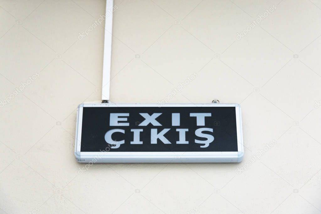 Exit sign in two languages on the wall