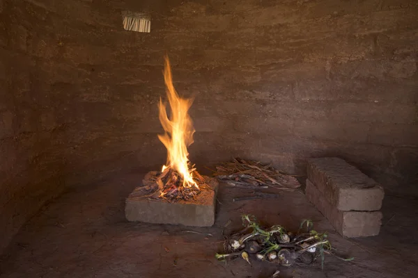 Lagerfeuer in primitiver Lehmhütte — Stockfoto