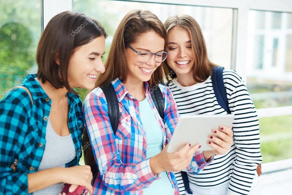 Student girls networking on digital tablet 