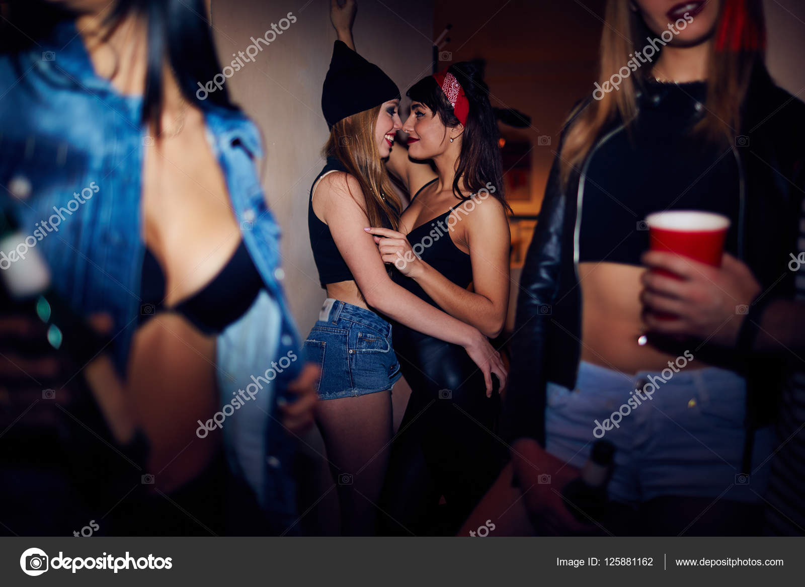 Drunk Girls Flirting at House Party Stock Photo by ©pressmaster 125881162