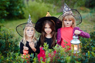 Spooky girls dressed as witches clipart