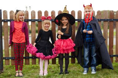 Cute friendly children in Halloween costumes  clipart