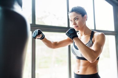 Female fighter practicing kickboxing exercise clipart