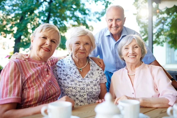 Smiling senior people looking at camera — Stockfoto