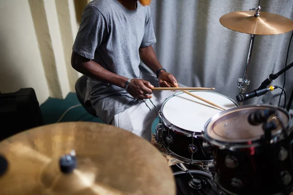 Man with drumsticks recording his music — Stock Photo, Image