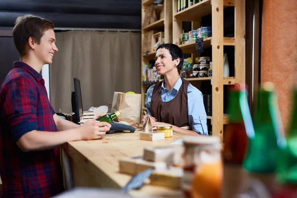 Junger Mann kauft Produkte im Supermarkt — Stockfoto