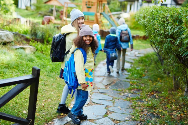 Happy schoolgirls going to school — Stock Photo, Image