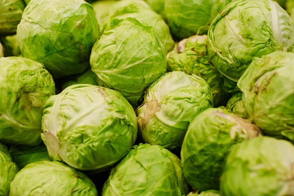 Stack of green cabbages in supermarket — Stock Image Stack of green cabbages in supermarket Stock Image