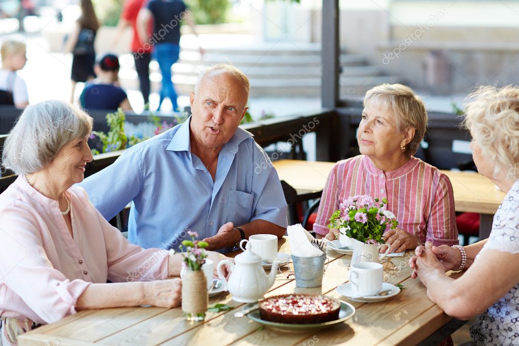 Senior friends having tea with dessert