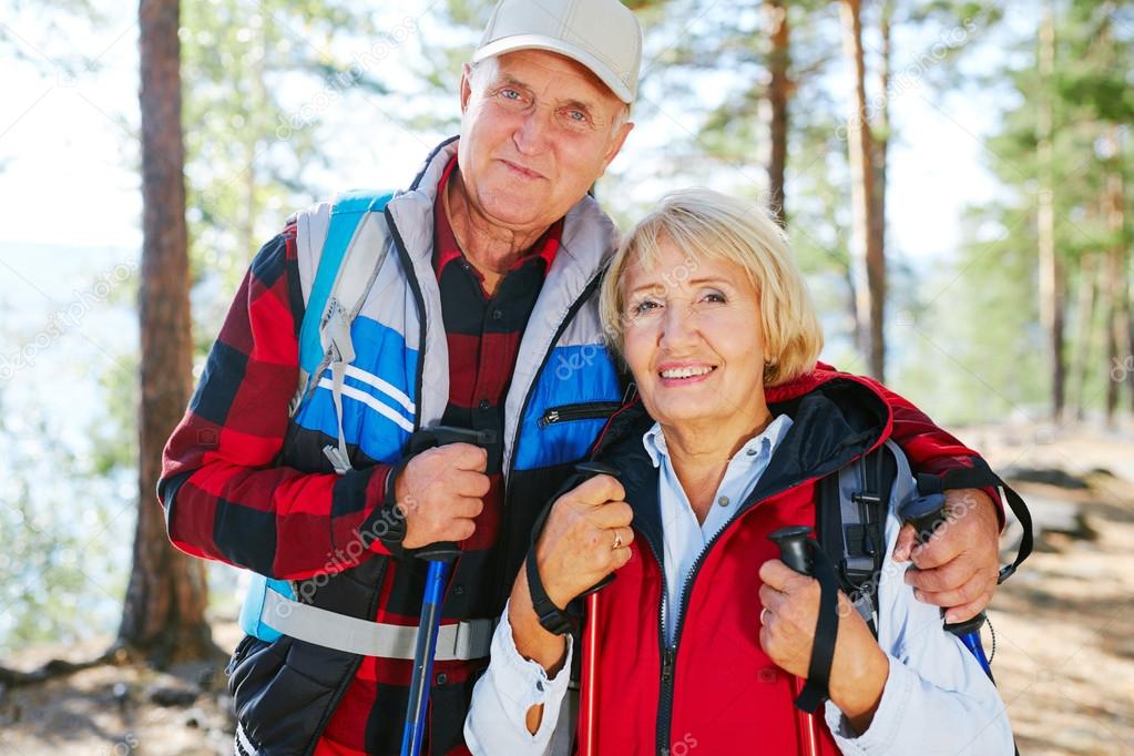Senior couple spending leisure by trekking