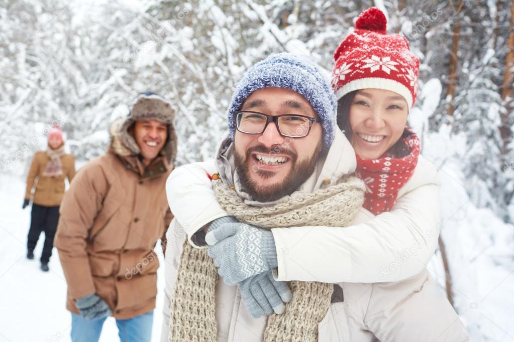 Couple and their friends having fun in winter