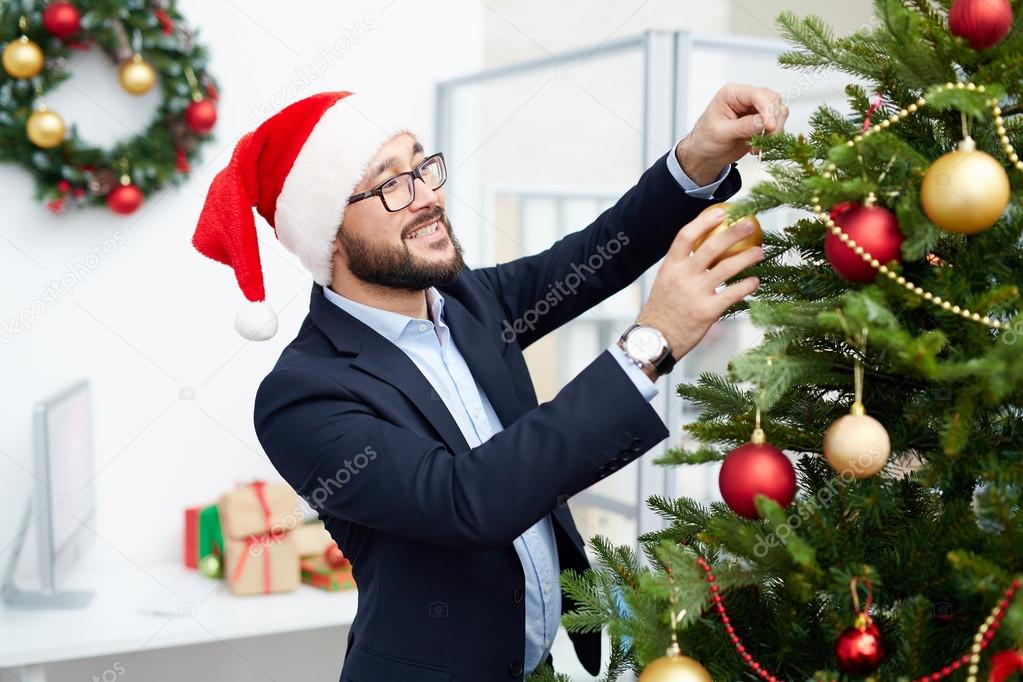 Businessman decorating xmas tree