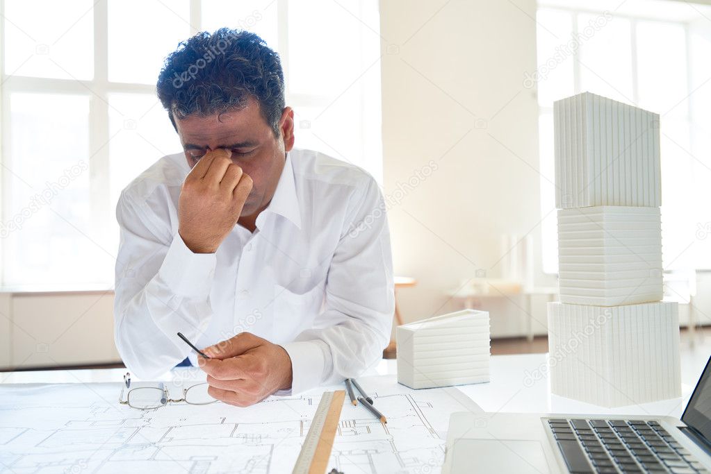 Tired businessman at his workplace
