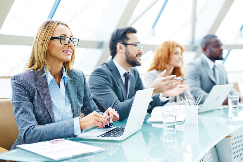 Manager sitting at conference for employees