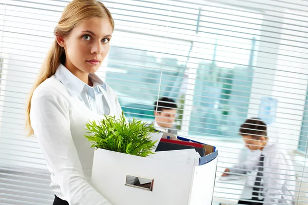 Businesswoman with cardboard box being fired — Stock Photo, Image