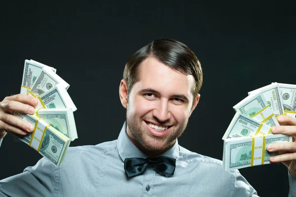 Excited man holding cash money — Stock Photo, Image