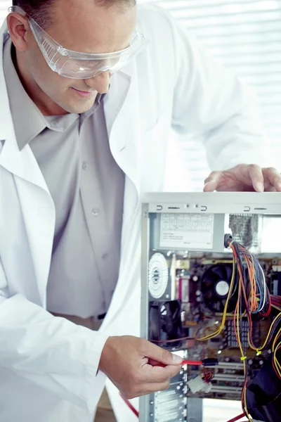 Молодий технік ремонтує комп'ютер — стокове фото