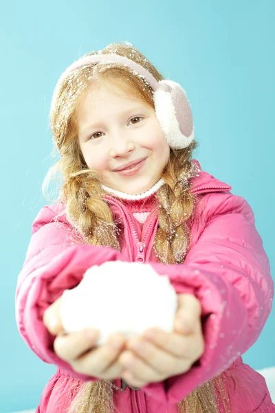 Girl in warm jacket holding snowball — Stock Photo, Image