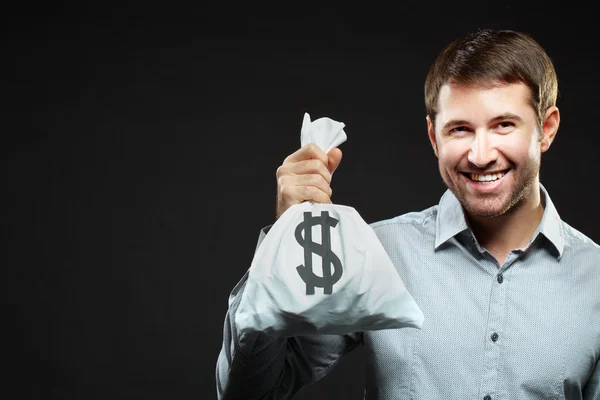 Happy man holding money bag — Stock Photo, Image