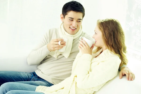 Молодая пара пьет чай дома — стоковое фото