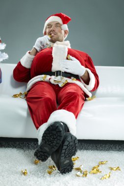 Obese Santa Claus chewing sweets   clipart