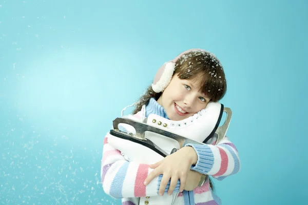 Little girl holding pair of skates — Stock Photo, Image