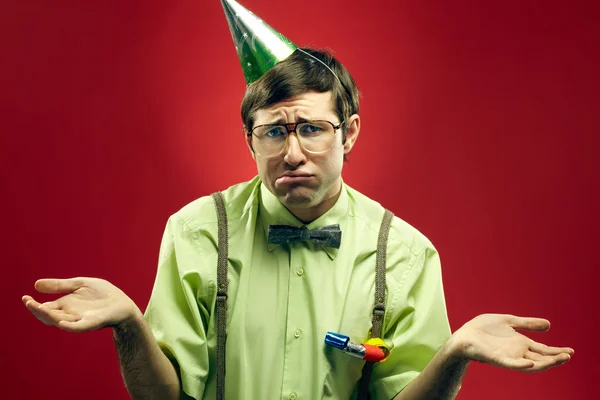 Sad nerd in party hat — Stockfoto