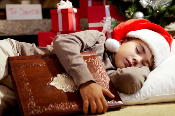 睡着的男孩在圣诞树下 — 图库照片