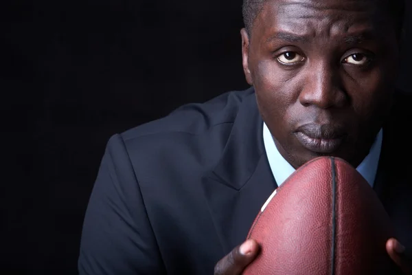 Serious businessman with rugby ball — Stock Photo, Image